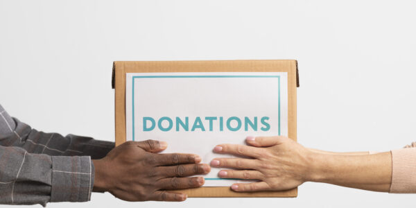 volunteer-giving-box-with-donations-another-volunteer